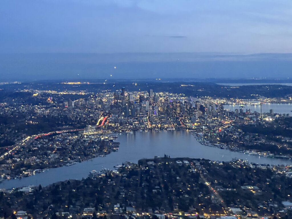 Aerial view looking south from Lake Union to downtown Seattle, note the traffic on I-5 and the air traffic (the white lights in the sky), which are airliners lined up for final approach into SEATAC. 29 March 2023 by Daryl Greaser