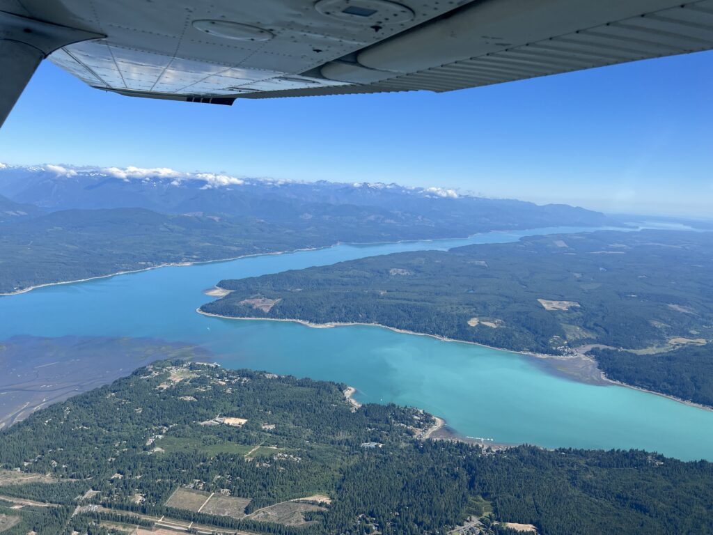 Aerial photo of The Great Bend of Hood Canal, Skokomish Flats (mouth of the Skokomish River) visible to the left. 2 July 2023 by Daryl Greaser