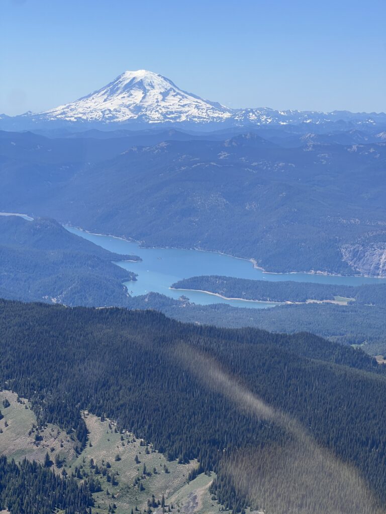 Gorgeous Rimrock Reservoir below 14,000-foot Tahoma hides Tieton State Airport (4S6) at the bottom right corner of the lake. We snapped this photo while flying a Cessna 172 between Goldendale and Ellensburg in June 2025.